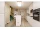 Functional kitchen with white cabinetry, modern appliances, and ample counter space at 3601 Swann St, Raleigh, NC 27612