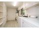 Well-lit laundry room with modern washer/dryer, sink, and storage cabinets at 3601 Swann St, Raleigh, NC 27612