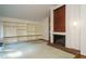Comfortable living room featuring built-in shelves, a cozy fireplace, and ample natural light at 3601 Swann St, Raleigh, NC 27612
