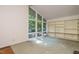 Spacious living room with large windows, built-in shelving, and a cozy ambiance at 3601 Swann St, Raleigh, NC 27612