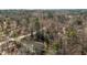 A high angle shot of a property surrounded by trees and a long driveway at 3741 Manly Farm Rd, Wake Forest, NC 27587