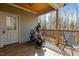 Outdoor porch with an exercise bike, chair, and serene wooded views at 3741 Manly Farm Rd, Wake Forest, NC 27587