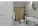 Bathroom with a pedestal sink, toilet, and shower with curtain at 3741 Manly Farm Rd, Wake Forest, NC 27587