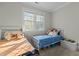 Bright bedroom featuring two twin beds and a large window at 3741 Manly Farm Rd, Wake Forest, NC 27587