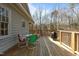Cozy deck with colorful chairs, dining table, grill, and wooded views at 3741 Manly Farm Rd, Wake Forest, NC 27587