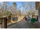 Wood deck with grill, dining table, and chairs overlooking trees at 3741 Manly Farm Rd, Wake Forest, NC 27587