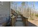 Wooden stairs lead up to backyard deck with views of the surrounding woods at 3741 Manly Farm Rd, Wake Forest, NC 27587