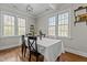 Dining room featuring hardwood floors, many large windows and seating for four people at 3741 Manly Farm Rd, Wake Forest, NC 27587