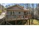 Home exterior view featuring a deck with outdoor dining set in a wooded setting at 3741 Manly Farm Rd, Wake Forest, NC 27587