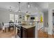 Open-concept kitchen features granite countertops, stainless appliances, and is open to the living area at 3741 Manly Farm Rd, Wake Forest, NC 27587