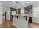 Modern kitchen with stainless steel appliances, granite countertops, and access to the laundry room at 3741 Manly Farm Rd, Wake Forest, NC 27587