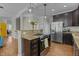 Modern kitchen features granite countertops, stainless appliances, and is open to the living area at 3741 Manly Farm Rd, Wake Forest, NC 27587