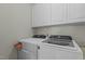 Laundry room featuring modern washer, dryer and upper cabinets for storage and organization at 3741 Manly Farm Rd, Wake Forest, NC 27587