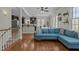 Bright living room features hardwood floors, blue sofa, and is open to dining and kitchen at 3741 Manly Farm Rd, Wake Forest, NC 27587