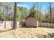 Backyard shed with wooden fence and many trees in the background at 40 Golden Timber Cir, Four Oaks, NC 27524