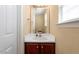 Well-lit half bath with vanity, sink, mirror, and cabinet storage at 40 Golden Timber Cir, Four Oaks, NC 27524