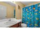 This bathroom features a sink with vanity, a mirror, and a shower with a fish curtain at 40 Golden Timber Cir, Four Oaks, NC 27524