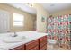 This bathroom has a sink with vanity, a mirror, and a shower with colorful curtain at 40 Golden Timber Cir, Four Oaks, NC 27524