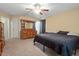Carpeted bedroom with warm paint, ceiling fan, and closet at 40 Golden Timber Cir, Four Oaks, NC 27524