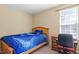 This bedroom includes a bed, a window, a desk with chair, and neutral colored walls at 40 Golden Timber Cir, Four Oaks, NC 27524