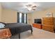 This bedroom features carpet, a ceiling fan, a window, and neutral-colored walls at 40 Golden Timber Cir, Four Oaks, NC 27524