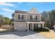 Charming two-story home with grey siding, black shutters, and a cozy front porch at 40 Golden Timber Cir, Four Oaks, NC 27524