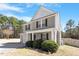 Charming two-story home with gray siding, black shutters, and a cozy front porch at 40 Golden Timber Cir, Four Oaks, NC 27524