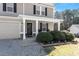Close up of the home's covered front porch, with landscaping and a stone accent at 40 Golden Timber Cir, Four Oaks, NC 27524