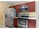 Bright kitchen with stainless steel appliances, including a refrigerator, oven, and microwave at 40 Golden Timber Cir, Four Oaks, NC 27524
