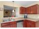 Well-lit kitchen featuring stainless steel dishwasher, and warm wood cabinets at 40 Golden Timber Cir, Four Oaks, NC 27524