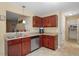 Cozy kitchen with stainless steel dishwasher, dual basin sink, and warm wood cabinetry at 40 Golden Timber Cir, Four Oaks, NC 27524