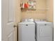 This laundry room has a washer, dryer, and shelves at 40 Golden Timber Cir, Four Oaks, NC 27524