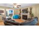 Cozy living room featuring a fireplace, ceiling fan, and comfortable, modern furnishings at 40 Golden Timber Cir, Four Oaks, NC 27524
