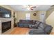Living room with a fireplace, hardwood floors, neutral paint, and a modern sectional sofa at 40 Golden Timber Cir, Four Oaks, NC 27524