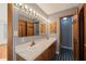 Bathroom with a double vanity, wallpaper, and blue tiled flooring at 405 Lookout Pt, Rougemont, NC 27572