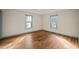 Bedroom with wood floors and two large windows for plenty of natural light at 405 Lookout Pt, Rougemont, NC 27572