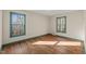 A bedroom featuring two windows offering natural light, complemented by polished hardwood floors at 405 Lookout Pt, Rougemont, NC 27572