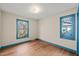 Bedroom featuring two windows for ample natural light and hardwood floors at 405 Lookout Pt, Rougemont, NC 27572