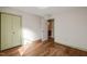 Bedroom featuring hardwood floors, a closet, and access to an ensuite bathroom at 405 Lookout Pt, Rougemont, NC 27572