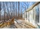 A spacious wood deck provides ample outdoor space to unwind, surrounded by the property's natural beauty and trees at 405 Lookout Pt, Rougemont, NC 27572
