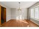 Dining room featuring hardwood floors, chandelier, and large window allowing lots of natural sunlight in at 405 Lookout Pt, Rougemont, NC 27572