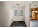 Bright entryway features double doors and dark stone tile flooring with a partial view of a kitchen at 405 Lookout Pt, Rougemont, NC 27572