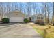 Charming exterior view features a well-maintained home with a two-car garage and inviting front entrance at 405 Lookout Pt, Rougemont, NC 27572