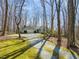 Well-maintained ranch style home with an attached garage nestled on a wooded lot with a long private driveway at 405 Lookout Pt, Rougemont, NC 27572
