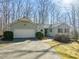 Charming home features a two-car garage, lush landscaping, and a welcoming entrance at 405 Lookout Pt, Rougemont, NC 27572