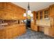 Spacious kitchen with wooden cabinets, modern appliances, tile flooring, and stylish lighting, offering functionality and charm at 405 Lookout Pt, Rougemont, NC 27572