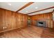 Living room with wood walls, hard wood floors, recessed lighting, and a charming brick fireplace at 405 Lookout Pt, Rougemont, NC 27572