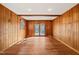 Living room featuring beautiful wood walls and flooring with plenty of natural light from the sliding glass doors at 405 Lookout Pt, Rougemont, NC 27572