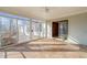 Sunroom with light wood flooring, sliding glass doors, and views of the outdoor deck and wooded lot at 405 Lookout Pt, Rougemont, NC 27572