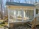 Enclosed sunroom featuring glass windows, a wood floor, and an attached deck, perfect for enjoying the outdoors from inside at 405 Lookout Pt, Rougemont, NC 27572